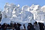 Visitors gather around a large snow sculpture called the snow 