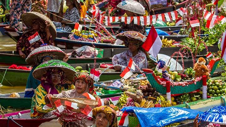 Pedagang pasar terapung menawarkan dagangannya dari atas perahu (jukung) saat Festival Budaya Pasar Terapung di Sungai Martapura, Banjarmasin, Kalimantan Selatan, Senin 15 Agustus 2022. Atraksi yang dilakukan puluhan pedagang pasar terapung  itu digelar unutk memeriahkan HUT ke-77 RI dan puncak HUT Provinsi Kalimantan Selatan ke-72. ANTARA FOTO/Bayu Pratama S