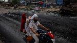 Sebuah keluarga mengendarai sepeda motor di jalan sepi selama jam malam yang diberlakukan oleh pihak berwenang menyusul bentrokan antara umat Hindu dan Muslim di distrik Nuh, negara bagian utara Haryana, India, 1 Agustus 2023. REUTERS/Adnan Abidi